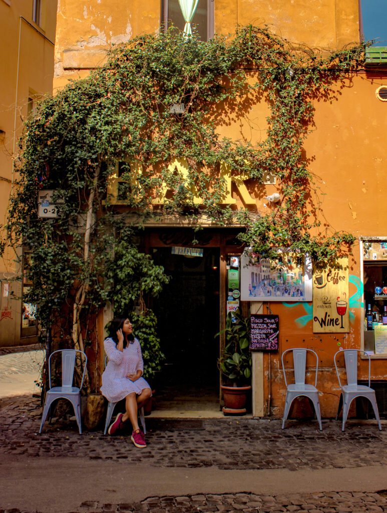 pretty italian colourful cafe with outdoor seating and ivy covered walls